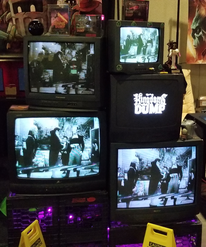 Multiple CRT displays, one with the title "Kingdoms Dump".