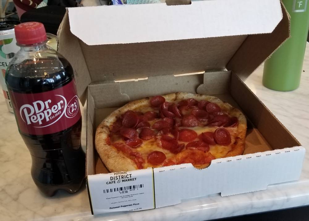 Photo of a Dr. Pepper and a small personal pizza.