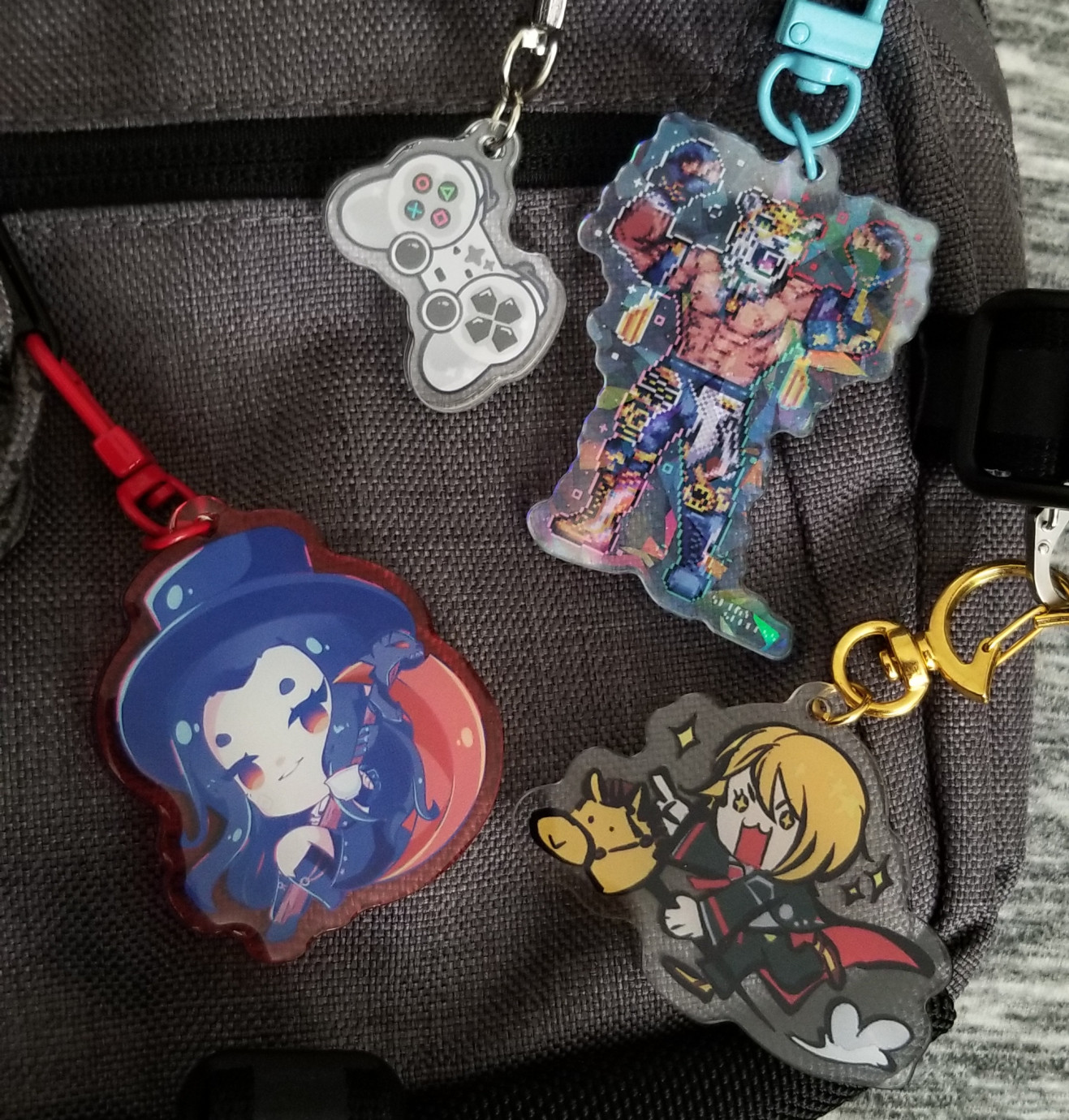 A close up shot of a sling bag. Showing off the various acrylic charms hanging off it.